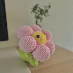 Handmade crocheted pink yellow and green flower plushie